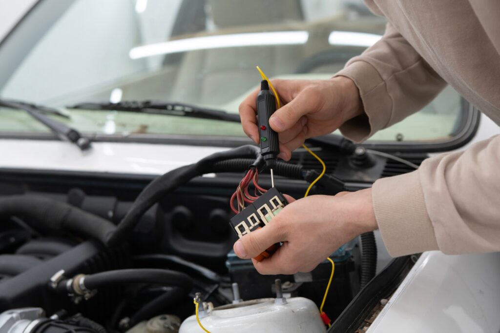 Car Mechanic Uses Auto Diagnostic Tester